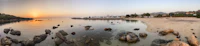 a panoramic view of a beach at sunset