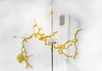 a white wall with a yellow lamp on it