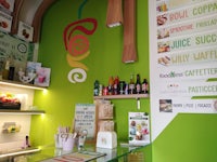a green kitchen with a lot of food on the wall