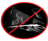 a black and white image of a man playing a piano