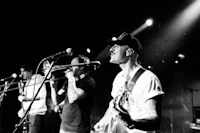 a black and white photo of a group of musicians on stage