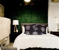 a black and white bedroom with a green wall