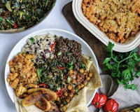 a variety of dishes on a wooden cutting board