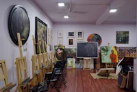 a room full of paintings and easels