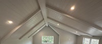 a room with a vaulted ceiling and white walls