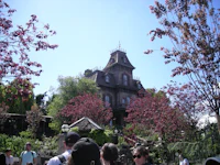 a group of people standing in front of a house