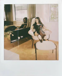 a woman sitting on a chair in front of a mirror