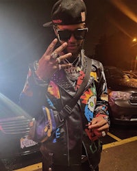 a man wearing a colorful jacket and sunglasses