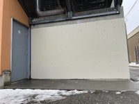 a building with a door that is covered in snow