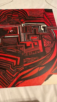 a red and black drawing on a table