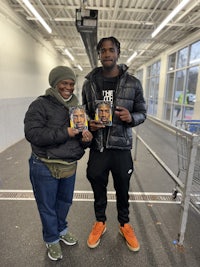 two people standing next to each other in a grocery store