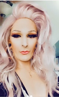 a woman with a pink wig posing for a selfie