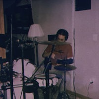 a man playing drums in a recording studio