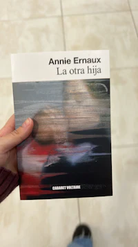 a person holding a book with the title annie erraux
