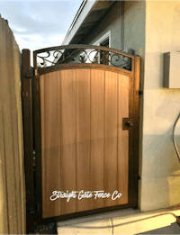 a wooden gate in front of a house