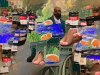 a man is standing in front of a jar of oranges