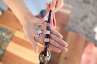 a person holding a spoon with a charm on it