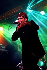 a man singing into a microphone on stage