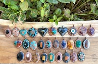a group of copper pendants on a wooden board