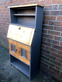 a wooden desk with drawers and a door