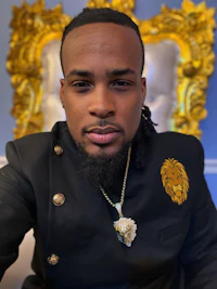 a man with dreadlocks and a lion on his head