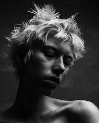 a black and white photo of a woman with short hair