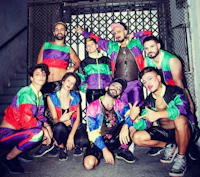 a group of people in colorful outfits posing for a photo