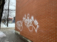 graffiti on the side of a brick wall