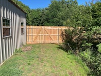 a small backyard with a wooden fence