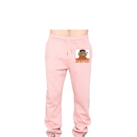 a man wearing a pink sweatpants with an orange logo on them