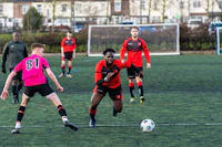 a group of men playing soccer on a field