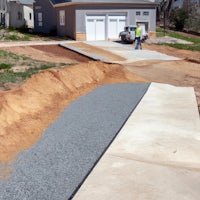 a man is working on a driveway