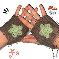 a pair of crocheted fingerless mitts with flowers on them