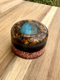 a small box with a blue and brown stone in it