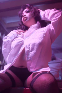 a woman wearing a white shirt and stockings