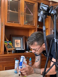 a man is using a camera on a table