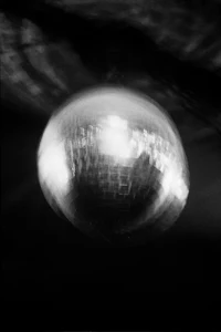a black and white photo of a disco ball