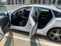 a white honda accord sedan with the door open
