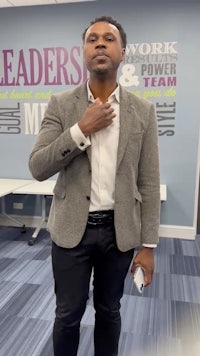 a man in a suit standing in an office