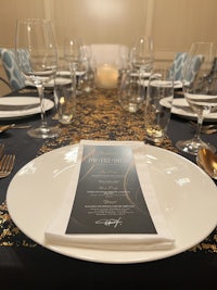 a table setting with a black and gold tablecloth