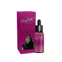 a bottle of pink hair oil with a woman's face next to it