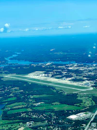 an aerial view of an airport with a runway in the background