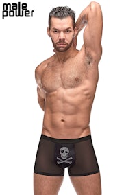 a man is posing in a boxer brief with a skull and crossbones
