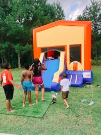 a group of children playing in an inflatable bounce house