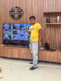 a man standing in front of a tv