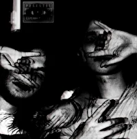 a black and white photo of two people holding their hands up