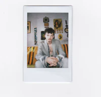 a photo of a man sitting on a couch