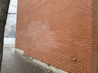 a red brick building with a fire hydrant next to it