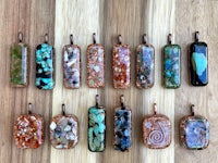 a group of different stone pendants on a wooden table