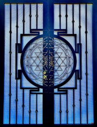 a stained glass door with a symbol of the flower of life on it